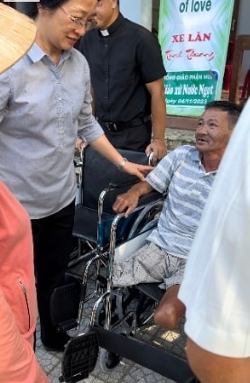 Wheelchairs Of Love — board members with Wheelchair of Love banners