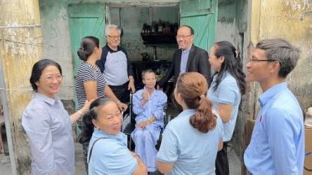 Wheelchairs Of Love — community gathering at doorway